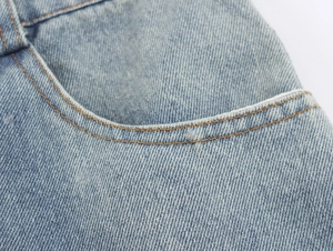 Detail shot of light blue denim midi skirt waist and side pocket craftmanship