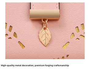 Detail of pink leaf pendant and premium gold hardware on lychee pattern leather purse