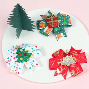 Detailed view of Christmas bow clips set with festive prints and glitter decorations