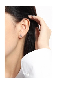 Close-up of minimalist S925 sterling silver bear stud earring worn on earlobe