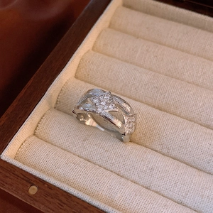 Close-up of silver rhombus zircon ring with brushed texture in a velvet jewelry box
