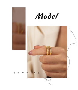 Close-up of geometric gold-plated double-layer ring with black stone and diamond texture
