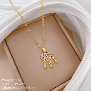 Detailed view of gold plated auspicious lock necklace with cubic zirconia on silk base