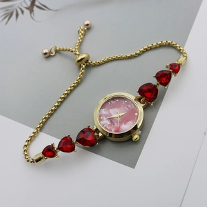 Detail of a women quartz watch with heart gemstone bracelet and pink marble dial