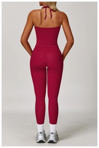 Back view of burgundy halter yoga set with high-waist leggings in matte finish texture