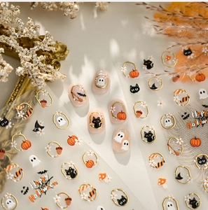 Detail of Halloween nail decals with cute ghosts and gold frames on natural nails