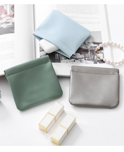 Three PU leather mini cosmetic pouches in blue green and gray with squeeze closure
