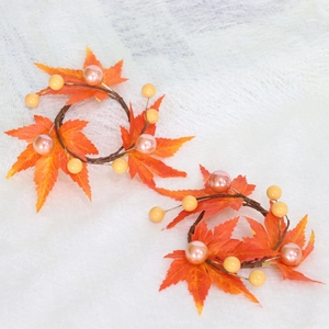 Detail of harvest maple leaf candle ring with autumn vines and elegant decorative pearls