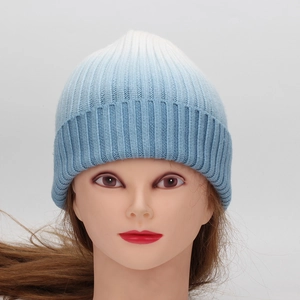 Detailed close-up of blue and white tie-dye knit beanie with ribbed cuff for winter warmth