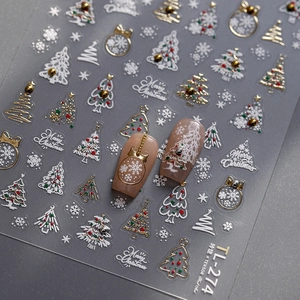 Golden Christmas nail art stickers with 3D embossed snowflakes and trees on grey background