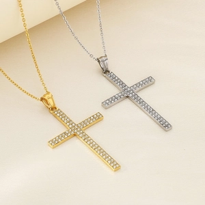 Close-up of gold and silver hip hop cross pendants with sparkling rhinestones details