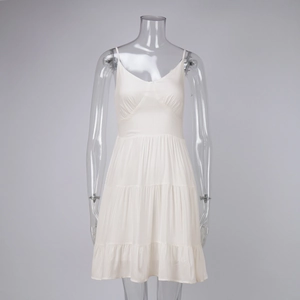 Detail of white cotton tiered summer dress showing textured fabric and layered ruffles