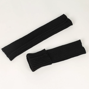 Close-up of black ribbed knit leg warmers showing high-quality texture and fabric detail