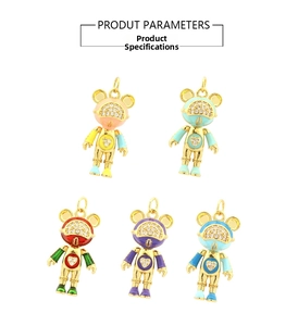 Macro detail of copper 18K gold plated astronaut bear pendants with colorful enamel