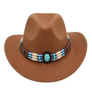 Detailed shot of turquoise stone ornament on brown felt western cowboy hat crown