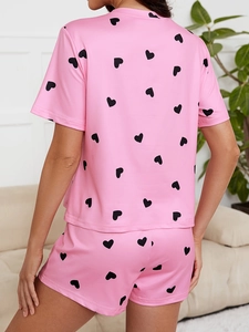 Rear view of soft pink pajamas set with heart print on short sleeve top and shorts