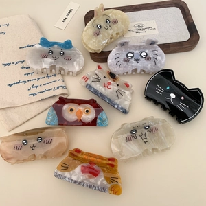 Variety of cute acetate cat and rabbit hair claws in a warm minimalist setting