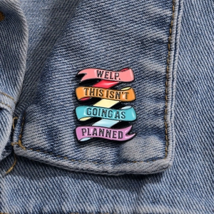 Colorful enamel inspirational quote brooch with humor text on denim jacket collar