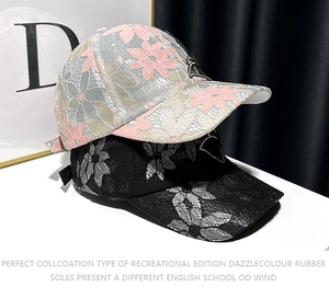 Detail showing elegant lace embroidery with delicate butterfly patch on baseball caps