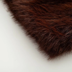 Close-up of deep brown faux fur vest showing soft plush texture and thick fabric detail