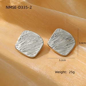Textured square hammer-effect titanium steel stud earrings on satin background