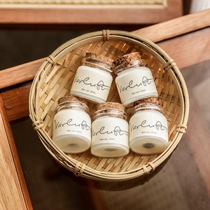 Set of five mini travel scented candles in small glass jars with natural cork lids