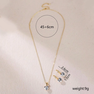 Gold stainless steel jewelry set with heart-shaped zircon pendant and matching earrings
