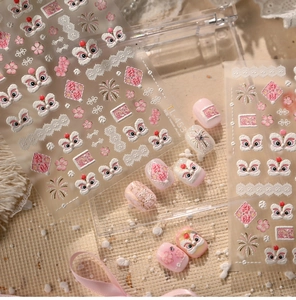 Macro detail of 5D embossed pink lion dance nail art stickers with gold floral accents