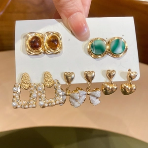 Detailed set of vintage French style gold earrings with pearls and emerald floral motifs