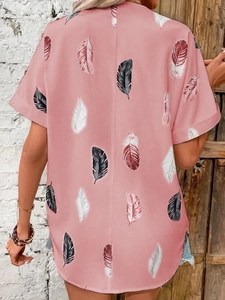 Detail of pink short sleeve shirt with vibrant black and white feather prints on back