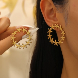 Golden stainless steel hoop earrings with textured star design for a minimalist look