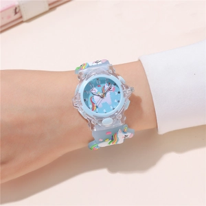 Macro detail of kids cartoon unicorn watch with light blue strap and clear plastic case