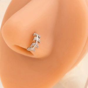 Detailed view of silver leaf nose stud with sparkling crystals on model nose