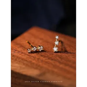 Elegant S925 sterling silver studs with three sparkling zircons in a gold plated finish