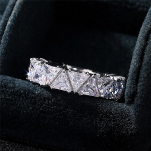 Macro shot of silver ring featuring row of triangle-cut sparkling zircon stones