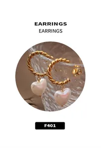 Detail of vintage gold twisted rope earrings with white heart-shaped pearl pendants