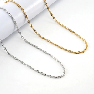 Minimalist 18K gold and silver stainless steel water wave chain necklaces on display