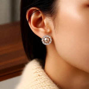 Close-up of 14k gold plated pearl flower earrings with marquise zircon on model