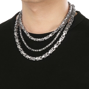 Close-up of various thicknesses of silver stainless steel flat Byzantine chain necklaces