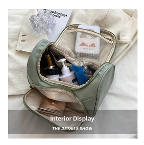 Large capacity green cosmetic bag, portable travel makeup organizer with zipper pockets.
