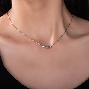 Minimalist silver titanium steel necklace featuring a sleek curved bean pendant for women