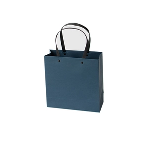 Minimalist navy blue paper gift bag with black woven handles for business packaging