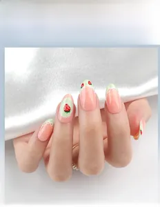 Detail of pink French almond press-on nails with strawberry motif and white lace lines