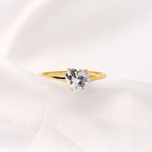 Close-up of heart-shaped white crystal ring in 18K gold plated stainless steel