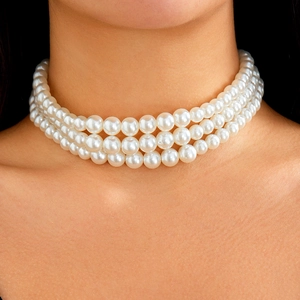 Close-up of three-layer white pearl choker necklace on model showcasing elegant luster