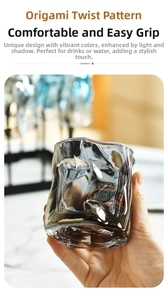 Detailed close-up of smoky gray origami style whiskey glass with twisted texture