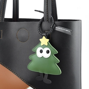 Cartoon Christmas tree PU leather bag charm with big eyes on a black tote bag