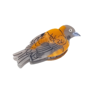 Unique bird-shaped acetate hair claw clip with yellow and grey patterns on white background
