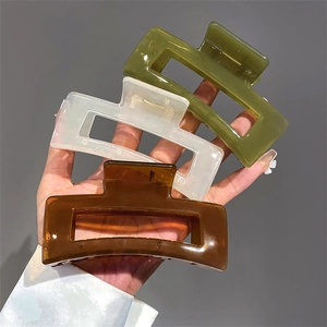 Three square matte hair claws in green, white, and brown colors for women's hair styling