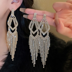 Close-up of sparkling rhinestone teardrop tassel earrings showing long dangle details